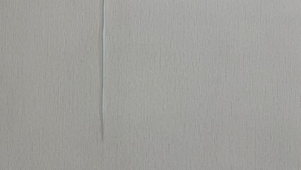 Wall peeling. Wallpaper background in the bedroom, cream fabric pattern.