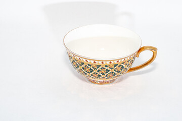 Antique Thai ceramics porcelain, Benjarong teacup and saucer isolated on white background.