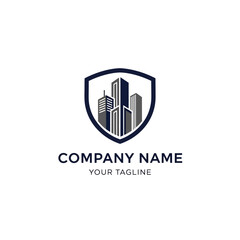 Modern real estate or security company logo with skyscrapers inside a protective shield emblem.