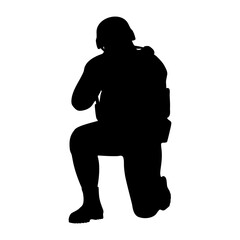 Soldier in combat gear kneeling silhouette