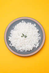 Boiled white rice on gray plate