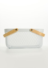 an iron basket with wooden handles on a white background