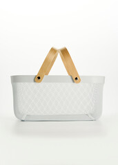 an iron basket with wooden handles on a white background