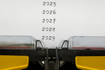 2025, 2026, 2027,2028,2029 written on an old typewriter	