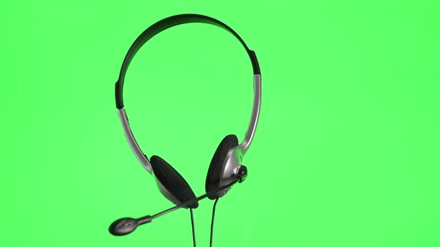 headphones with microphone on green screen background  chroma key 