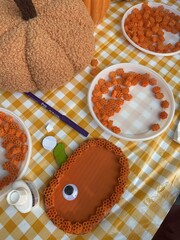 A master class on making pumpkin crafts at a beautifully decorated table for Halloween
