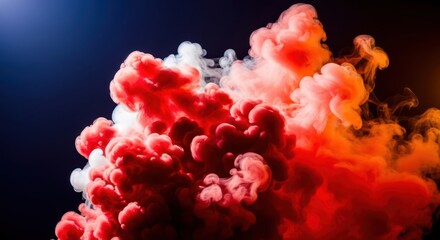 Fototapeta premium Vibrant red and orange smoke cloud exploding with dramatic intensity against a deep blue sky