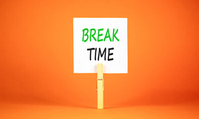 Break time symbol. Concept word Break time on beautiful white paper. Beautiful wooden clothespin. Beautiful orange background. Business break time concept. Copy space.