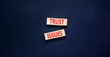 Trust issues symbol. Concept word Trust issues on beautiful wooden blocks. Beautiful black paper background. Business trust issues concept. Copy space.