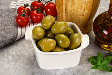 Big green marinated olives in the bowl
