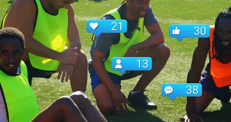 Team kneeling around ball as clip advancing social media icons appearing and boosting engagement - Powered by Adobe