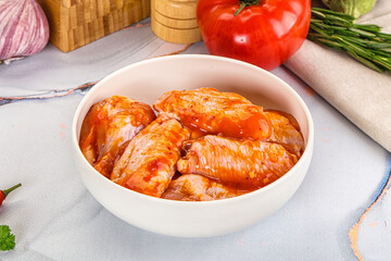 Raw marinated uncooked chicken wings