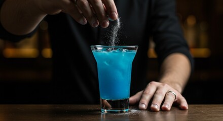 Close-up of bartender hand secretly adding substance to drink, concept of drink tampering and danger