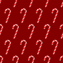 Seamless pattern of Christmas red and white striped sugar cane placed diagonally on a red background