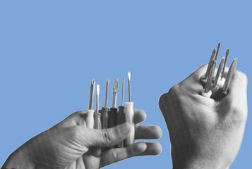 close up of hand holding many variants of tiny screwdrivers	pixelate grayscale color halftone dotted texture style collage element isolated on blue background