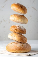 Fluffy golden brown dinner rolls floating in a stack, whimsical baking and bakery concept, creative and eye-catching food photography