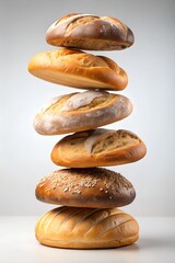 Stack of freshly baked bread rolls magically levitating in mid-air, surreal food concept on a clean background