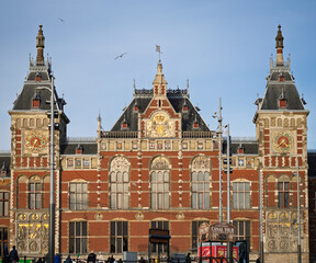 Amsterdam, Netherlands; February-24, 2025: View of the beautiful facade of Amsterdam Central Station (Netherlands) at sunset