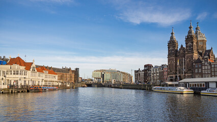 Tourist view of an Amsterdam canal at sunset