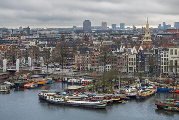 Amsterdam, Netherlands; February-24, 2025: View of the beautiful facade of Amsterdam Central Station (Netherlands) at sunset