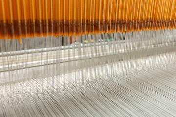 Jacquard loom heddles guiding warp threads in modern textile manufacturing