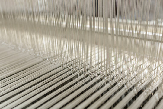 Modern jacquard loom heddles and warp threads in textile manufacturing