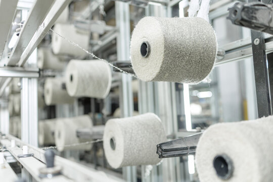Spinning production yarn cones on creel in modern textile factory