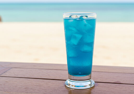 Refreshing blue tropical cocktail with ice on a wooden table by the beach, perfect for summer vacations and sunny resort getaways, drink responsibly
