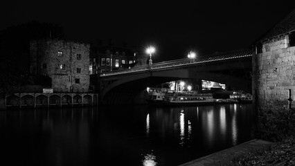 Fototapeta premium York night skyline and cityscape with the view of landmark Rendal Tower and historic Rendal Bridge over the River Ouse in the United Kingdom, a tranquil twilight monochromatic panorama.
