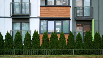 Residential building facade with green shrubs