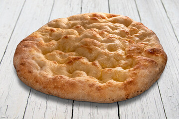 Typical Italian flatbread called focaccia or schiacciata on white wooden table with clipping path included