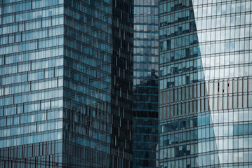 Fototapeta premium mirrored windows of the facade of an office building