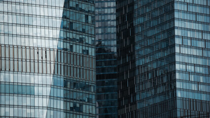 Fototapeta premium mirrored windows of the facade of an office building