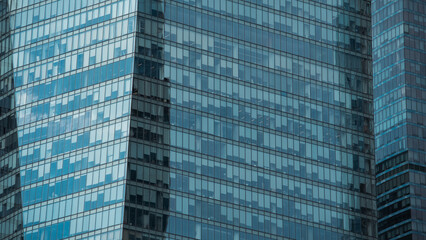Fototapeta premium mirrored windows of the facade of an office building