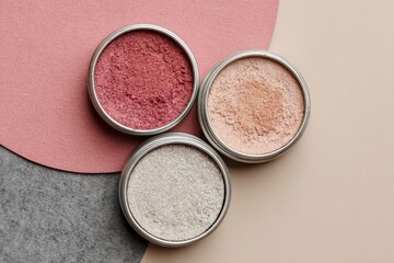 Fototapeta premium Three round, metal tins of blush/powder. Different shades of blush