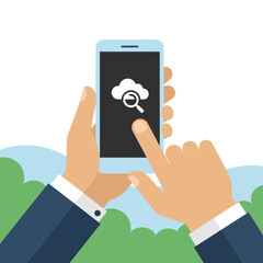 A close-up of a businessman’s hand holding and using a smartphone outdoors