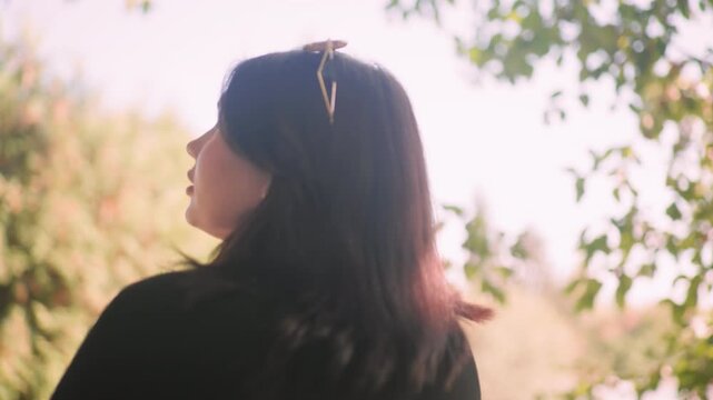 Medium back view of damsel strolling through pine grove thoughtfully, sunglasses on hair, soft bokeh, gentle breeze, quiet autumn mood, slow steps, relaxed exploration under green canopy