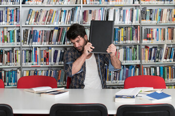 Frustrated Student Throwing His Laptop