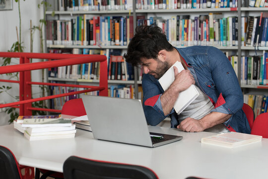 Bored Student With Books in Library