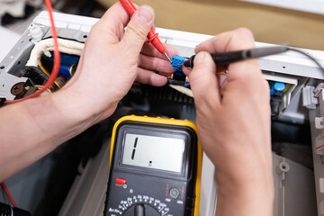 A technician is repairing electronics with a multimeter and tools, showcasing their skills