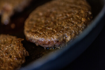 Juicy burger patties sizzling in hot pan, creating mouthwatering aroma for delicious home cooking