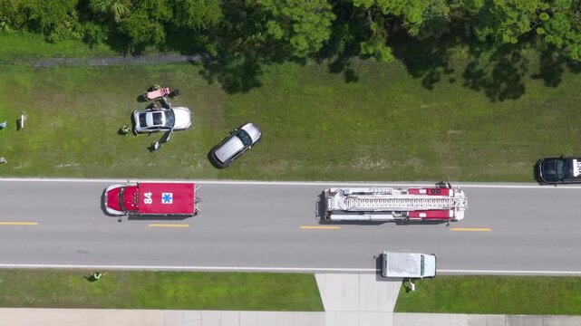 First responders treat a car accident victim, using a medical stretcher at the scene of a traffic incident on a public road in America.