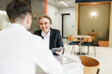 Business meeting between colleagues in modern office setting