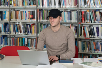 Student With Cap on Head Learning in Library