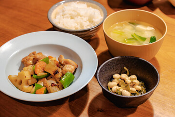 Japanese dinner with stir-fried chicken and vegetables, simmered soybeans, rice and miso soup
