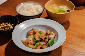 Japanese dinner with stir-fried chicken and vegetables, simmered soybeans, rice and miso soup
