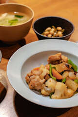 Japanese dinner with stir-fried chicken and vegetables, simmered soybeans, rice and miso soup
