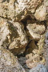 Rocky formations with rugged textures illuminated by sunlight creating natural geological pattern and atmosphere