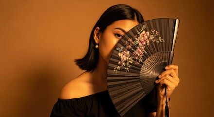 Young asian female with floral hand fan on brown background