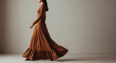 Elegant young asian female in flowing brown dress walking gracefully